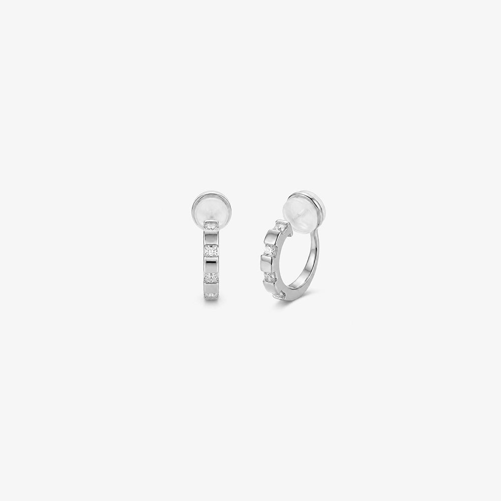 Front view of a pair of 16k white gold plated huggie clip on earrings with sparkling baguette cubic zirconia.
