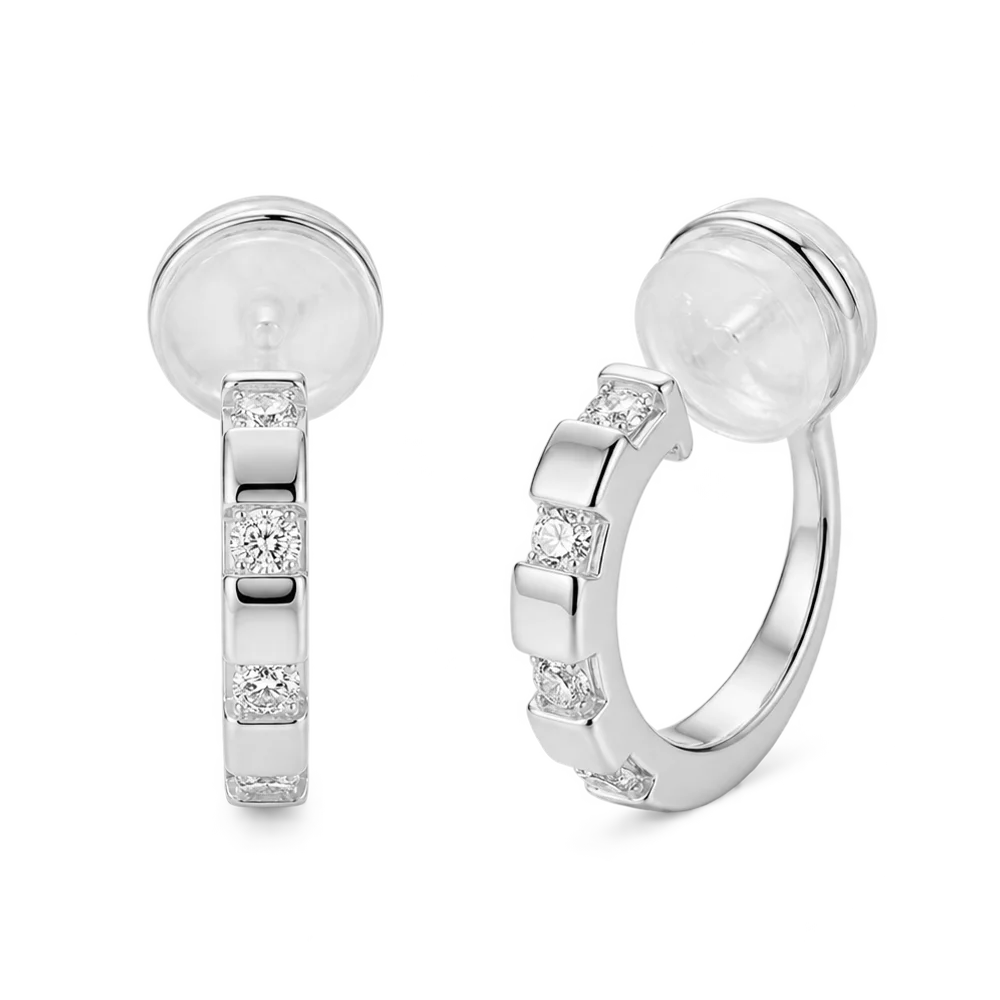 Front view of a pair of 16k white gold plated huggie clip on earrings with sparkling baguette cubic zirconia.