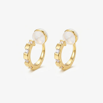 A pair of 16k yellow gold finished huggie clip on earrings with sparkling baguette cubic zirconia in a lattice setting.