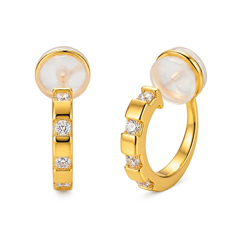 A pair of 16k yellow gold finished huggie clip on earrings with sparkling baguette cubic zirconia in a lattice setting.