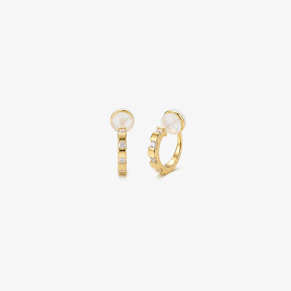 A pair of 16k yellow gold finished huggie clip on earrings with sparkling baguette cubic zirconia in a lattice setting.