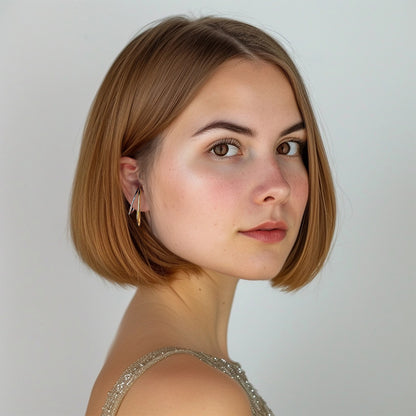 Portrait of a woman wearing the no-pierce Dual-Tone Wave Conch Ear Cuffs, where the interplay of gold and silver hues offers a modern twist suitable for date nights or upscale events.