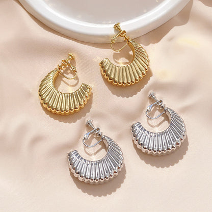 Embrace the Parisian chic with these Croissant Semi Hoop Clip-On Earrings. Their chunky silhouette in gold or silver alloy, secured with screw-back clip-ons, offers a tasteful blend of comfort and style. Perfect for adding a bold touch to any look.