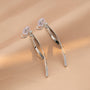 Boucles d'oreilles pendantes à clip en forme de ruban argenté, au design fin et minimaliste. Fabriquées en alliage avec une fermeture à clip en spirale confortable, elles sont parfaites pour être portées toute la journée, même sur des oreilles non percées.