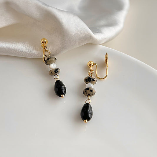 Channel your inner bohemian spirit with these stunning black gemstone drop earrings. Featuring a beautiful combination of natural black gemstone (stone) and lightweight resin, these earrings offer a touch of earthy elegance to any outfit.  The secure coil clip-on closure ensures comfortable wear for non-pierced ears.