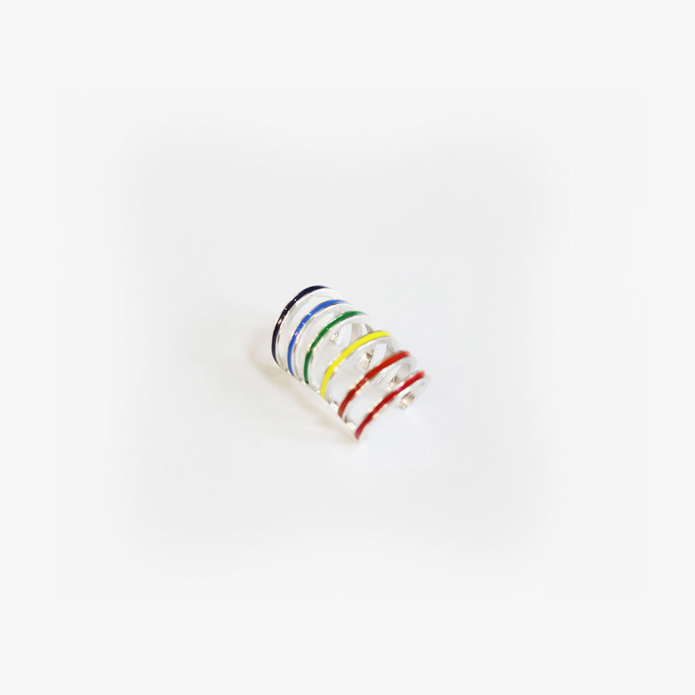 A close-up of a colorful Rainbow Conch Ear Cuff isolated on white, the sleek design ideal for work wear, adding a discreet yet whimsical element to professional attire.