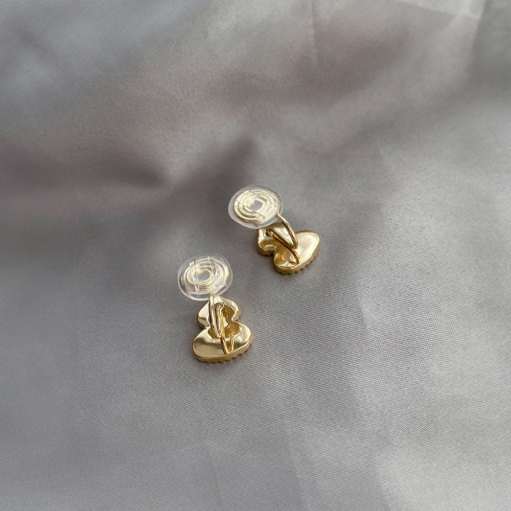 Petite Wulu clip-on earrings feature a mother-of-pearl design with sparkling zircons, all crafted in gold-tone alloy. Coil closure for comfort. Embrace good vibes with a touch of ancient Chinese symbolism.