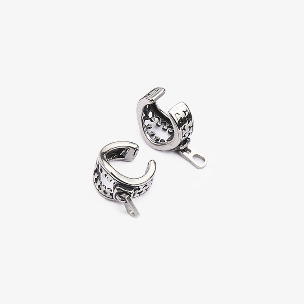 A pair of titanium steel Zipper Ear Cuffs with intricate zipper detailing, affordable designer ear cuffs. The conch cuffs embody a chic, urban aesthetic perfect for complementing an outfit for a date or a casual outing with friends.