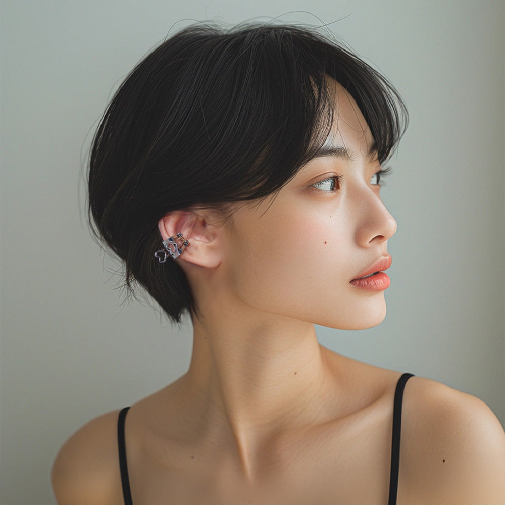 Woman wearing Heart Binder Clip Conch Ear Cuff in white gold, a quirky accessory for creative daily wear or a playful twist on date night outfits.