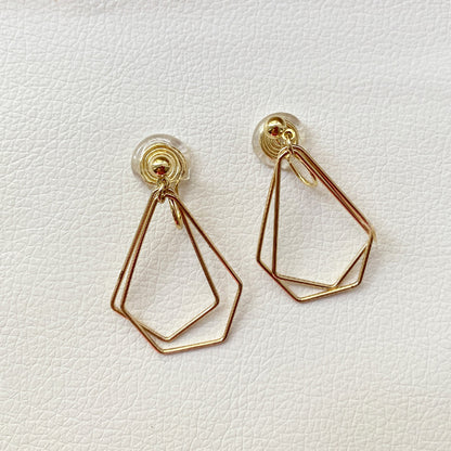 Gold-tone layered geometric clip-on earrings presenting a modern dangle style. Made from durable alloy, these earrings are designed with coil clip-on closures for a secure fit, suitable for non-pierced ears. Ideal for enhancing everyday or formal attire with a touch of elegance.