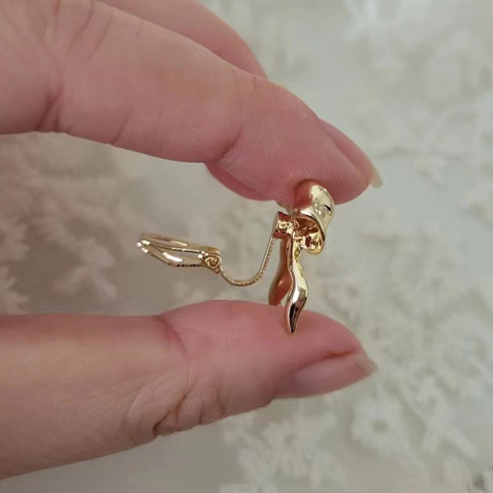 Gift-worthy gold bow clip-on stud earrings in gold. Perfect for a touch of ballerinacore elegance or a special occasion gift. Secure hinge back closure for comfort. 