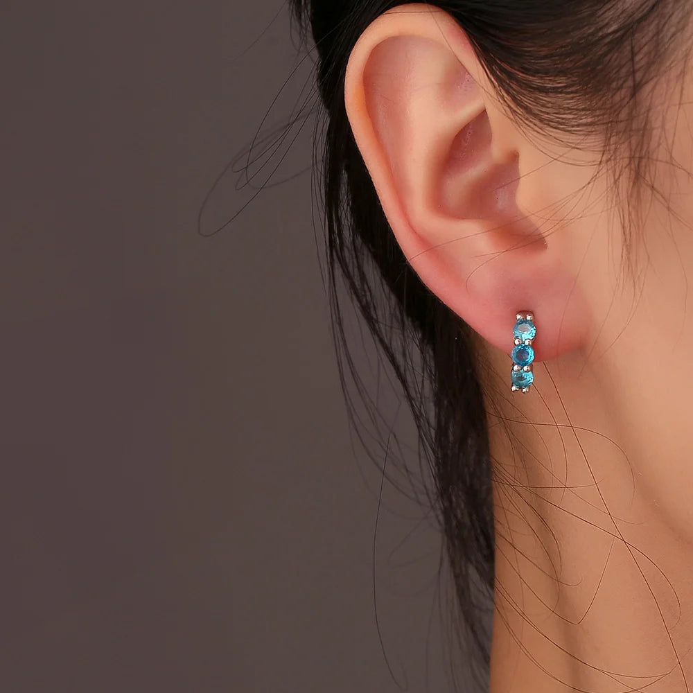 Model wearing Aquamarine Clip-On Hoop Earrings