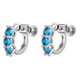 A pair of silver huggie hoop earrings with three faceted blue gemstones in each earring, shown on a plain white background.