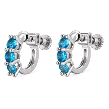 A pair of silver huggie hoop earrings with three faceted blue gemstones in each earring, shown on a plain white background.