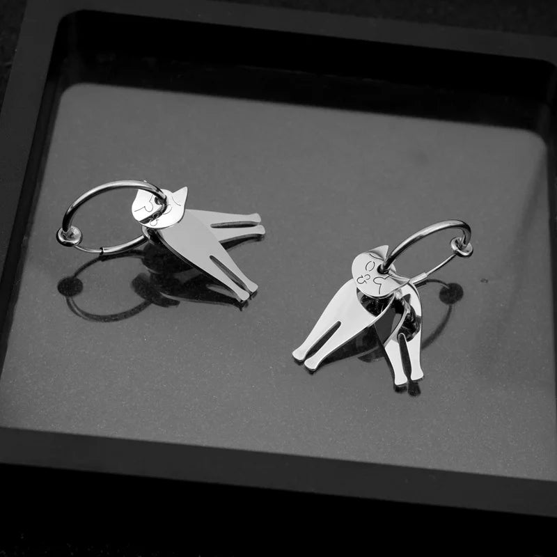 Stainless steel articulated cat clip-on earrings displayed on gray surface, silver finish, front view