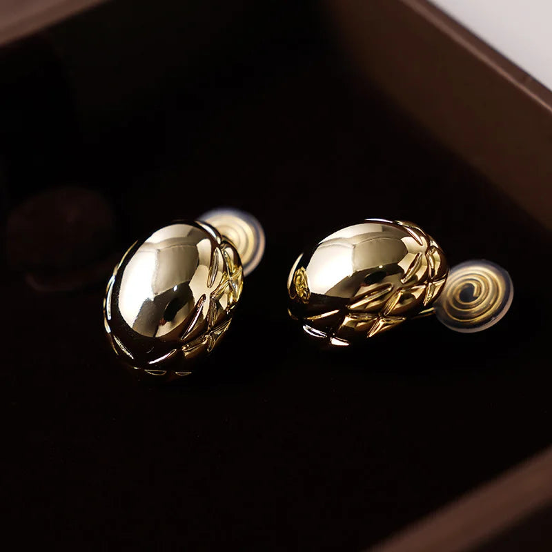 Side view of Basket Weave Oval Clip-On Earrings emphasizing the 16k gold plating and oval shape.