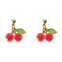 A pair of gold-tone cherry drop earrings with textured red cherry beads, green enamel leaves, shown on a plain white background.