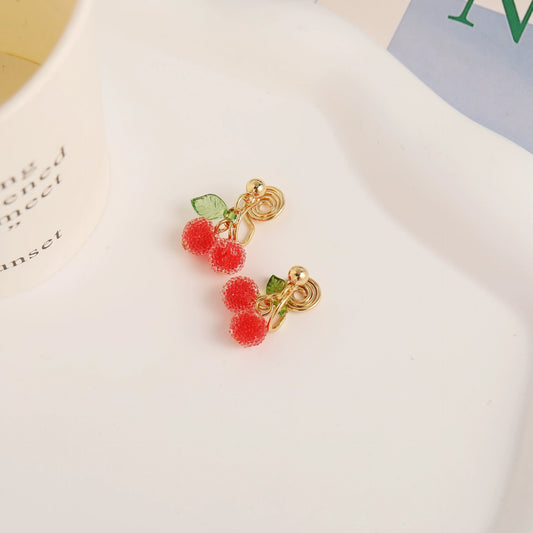 Elegant beaded cherry clip-on earrings featuring enamel leaf details.