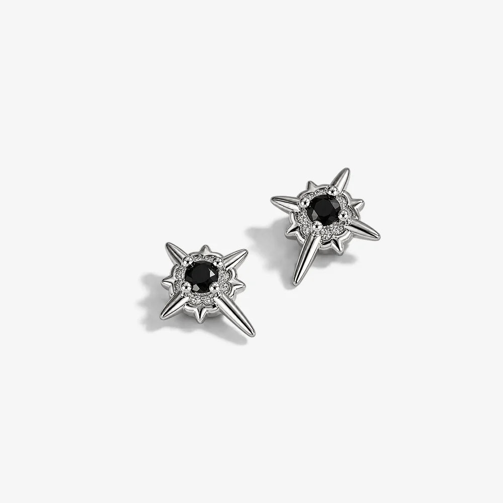 Star-shaped earrings with black stones on a white background with measurement scale.