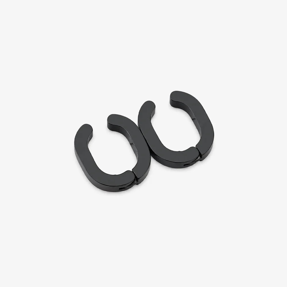 A pair of matte black split C-shaped hoop earrings on a clean, light gray background.