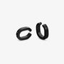 A pair of matte black metal chunky hoop earrings shown from two angles on a light gray background.