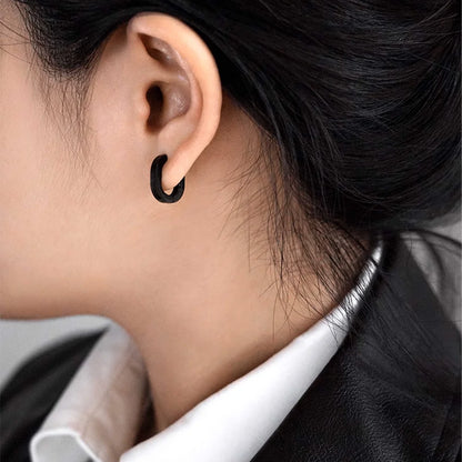 Model wearing Black Horseshoe Clip-On Hoop Earrings.