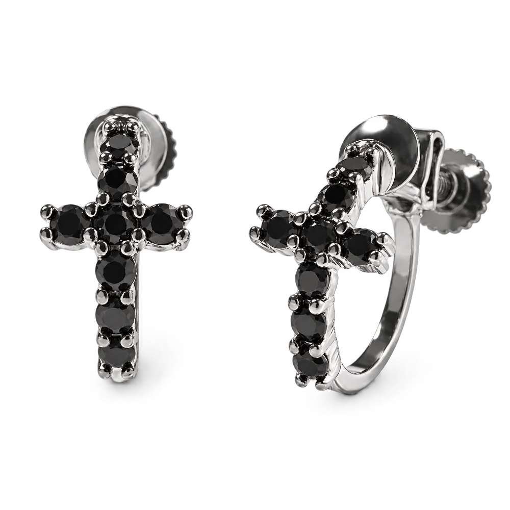 A pair of silver hoop earrings with small cross charms set with black gemstones, shown on a clean white background.