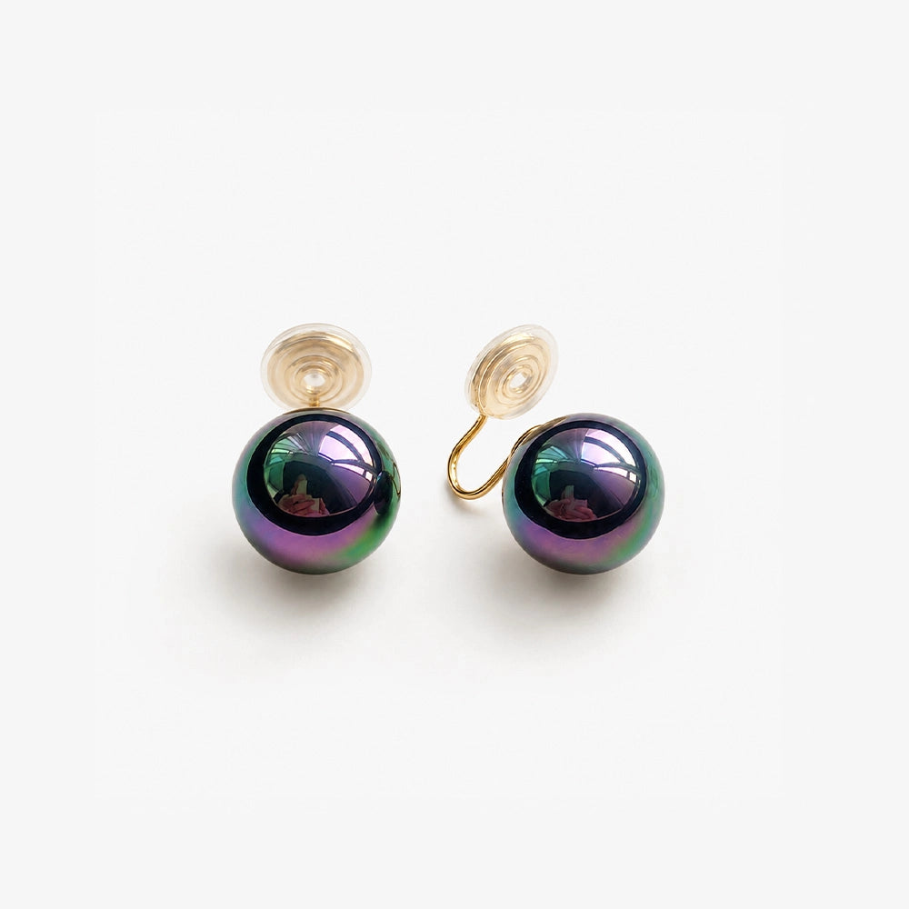 Pair of Black Pearl Clip-On Earrings displayed on a soft white surface, capturing the classic and timeless design.