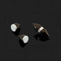 Black tapered magnetic stud earrings displayed at angles on dark background showing silver accents and sleek design