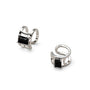 Pair of silver earrings with black stones and dangling elements on a white background