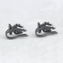 Black Trident Clip-On Ear Cuff pair displayed at angle on white background showing metal design and curved ear hook
