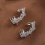 Blossom Flower Ear Cuff in White Gold, pair displayed on brown fabric showing detailed floral design and hook closures
