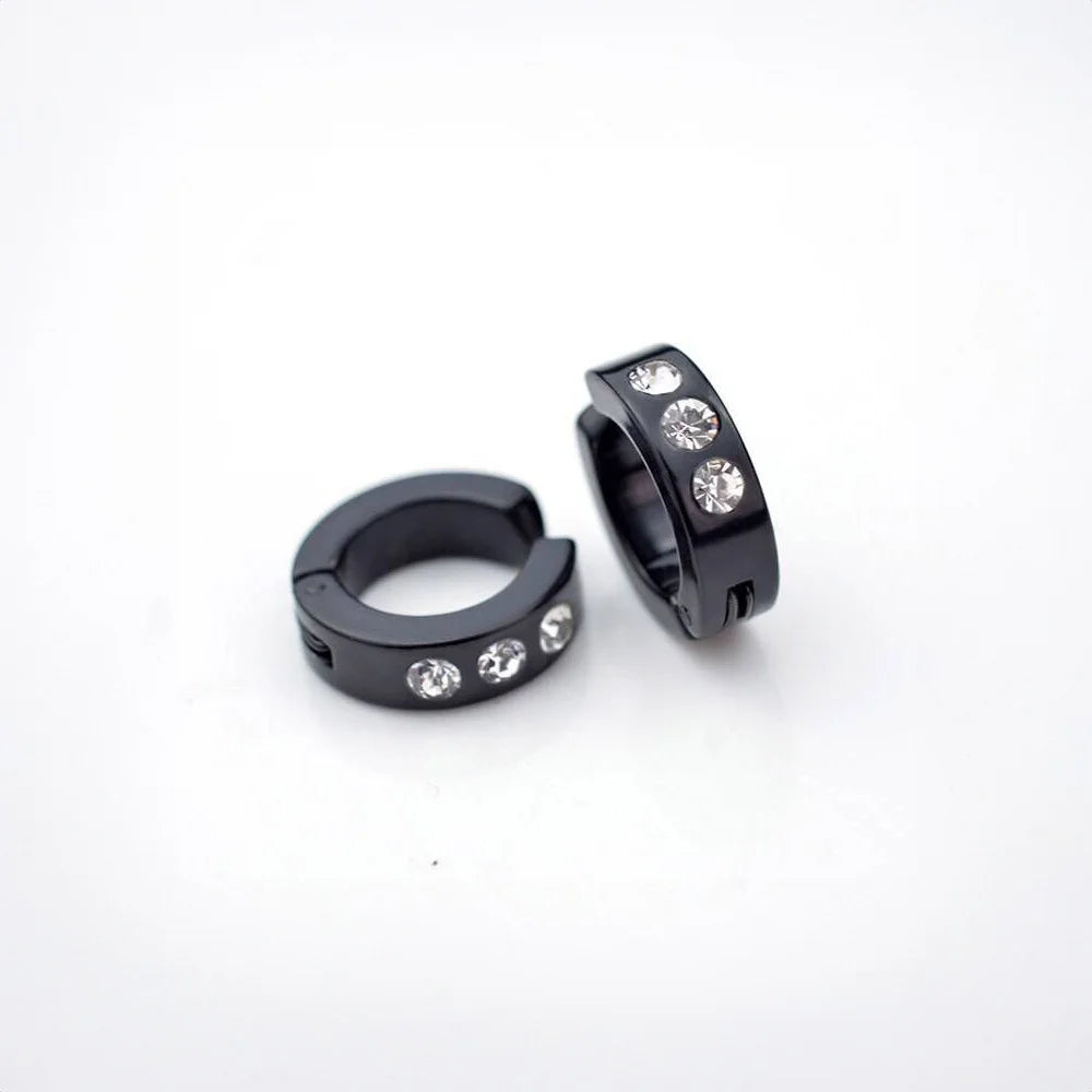 Black zirconia bold clip-on hoop earrings with crystal stones, angled view on white background