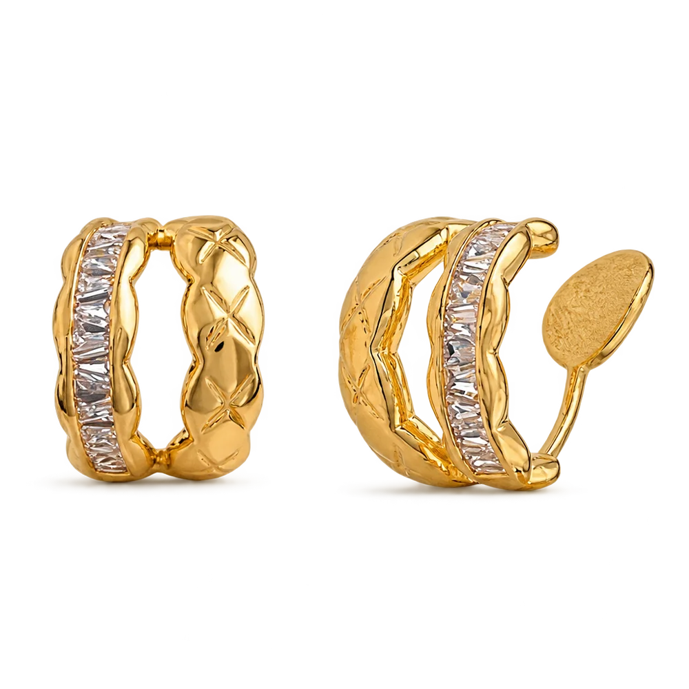 A pair of gold huggie hoop earrings with a channel-set row of clear baguette-cut stones, shown from both front and side angles on a white background.
