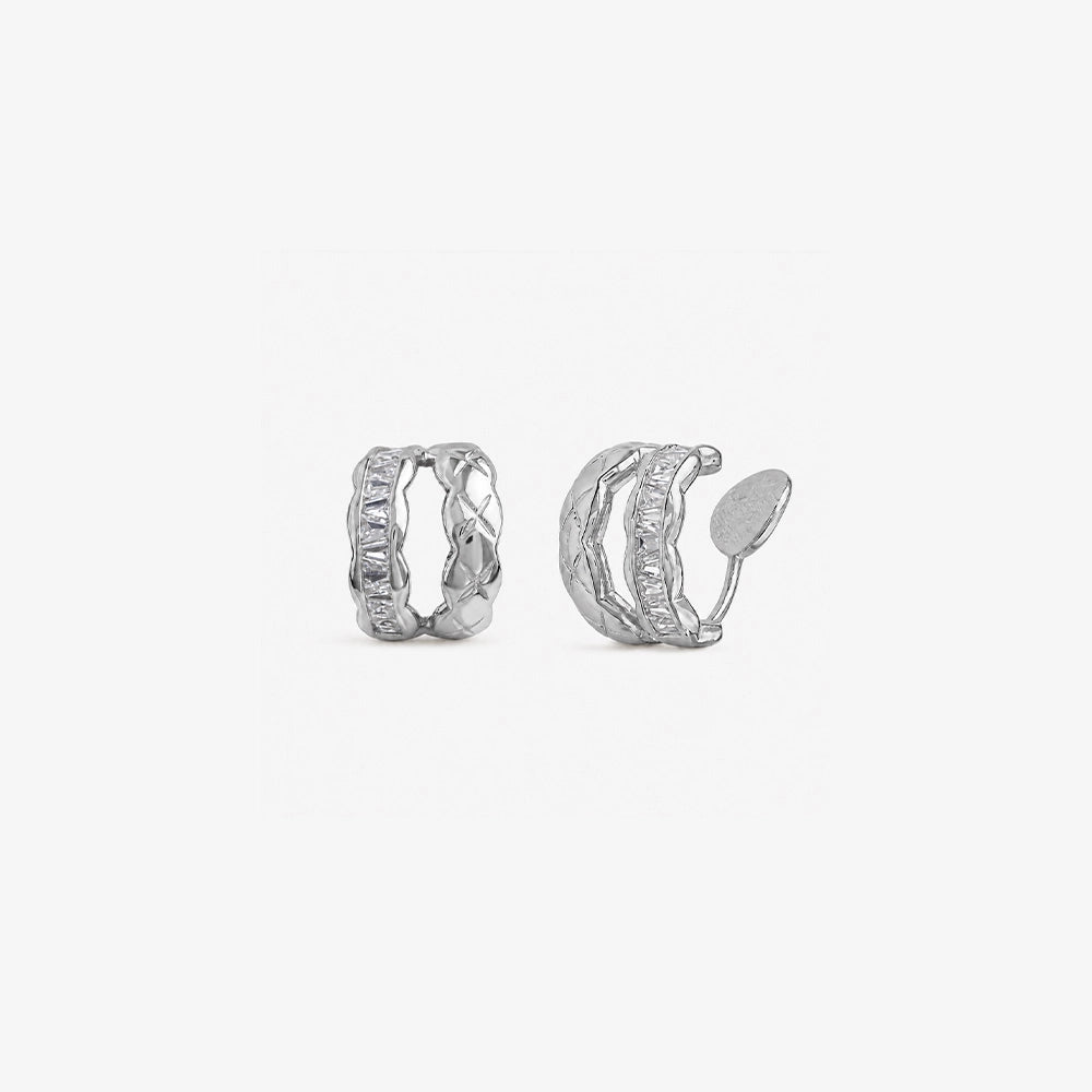 Pair of white gold hoop earrings with cubic zirconia on a white background