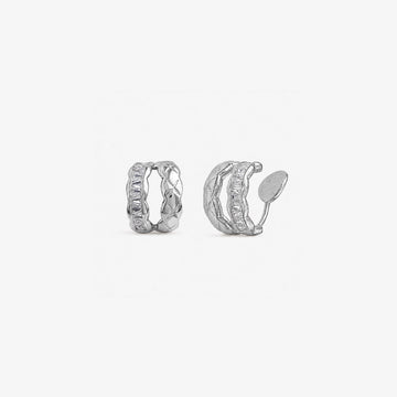 Pair of white gold hoop earrings with cubic zirconia on a white background