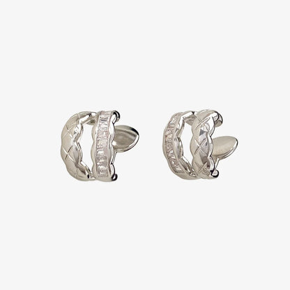 Pair of white gold hoop earrings with cubic zirconia on a white background
