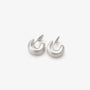 Brushed silver clip-on hoop earrings displayed on white fabric background, front view