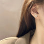 Silver butterfly zirconia invisible clip-on earrings side view worn on ear with brown hair