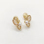 A pair of gold butterfly stud earrings decorated with white pearls and small clear rhinestones, set against a plain white background.