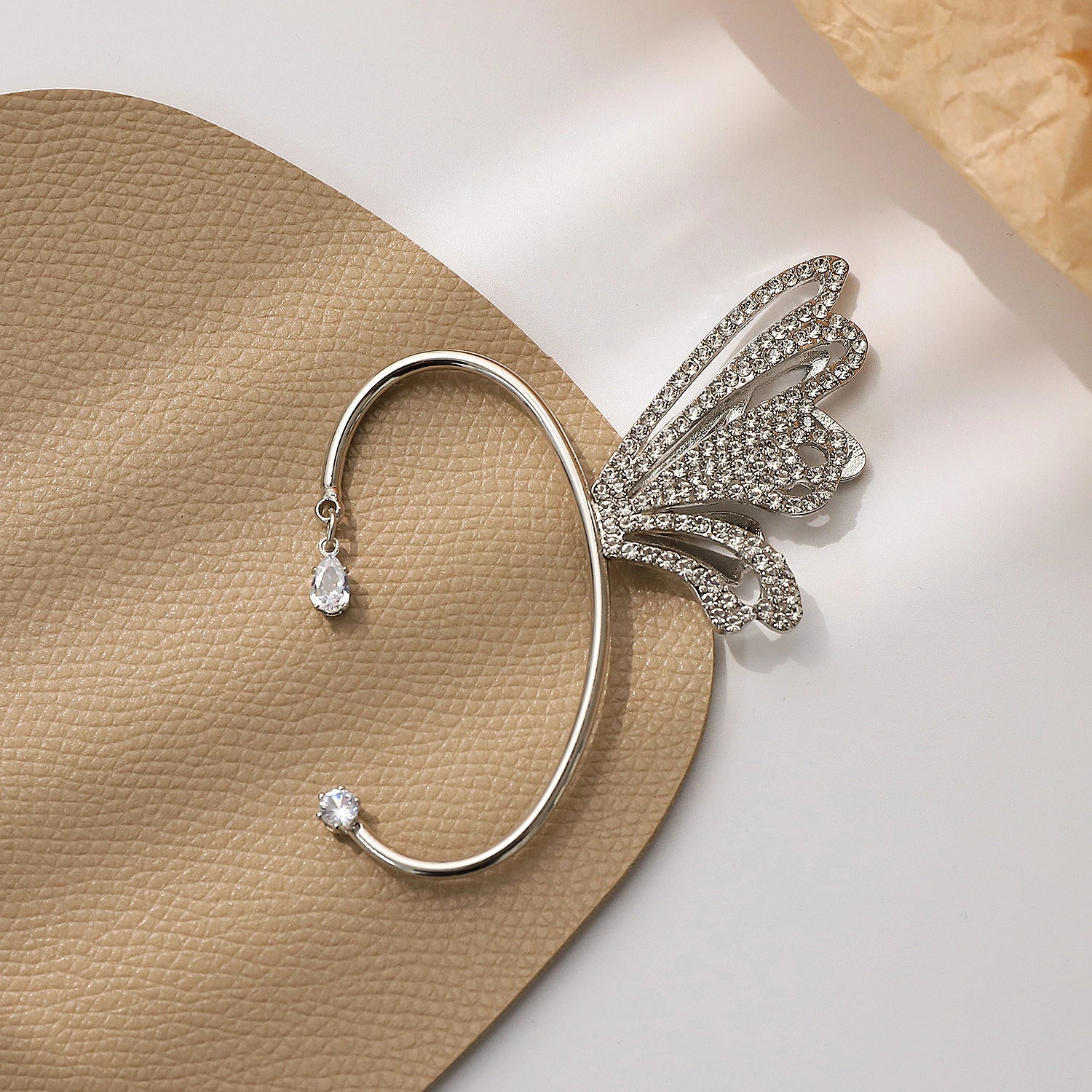 Close-up image of the Butterfly Wing Ear Cuff in White Gold, focusing on the luxurious white gold plating and sophisticated butterfly wing design.