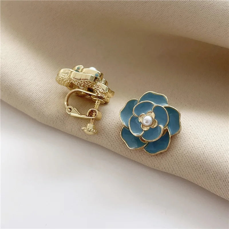 Stylish gold-plated copper alloy women's clip earrings with screw-back clip-on design, shown in blue.