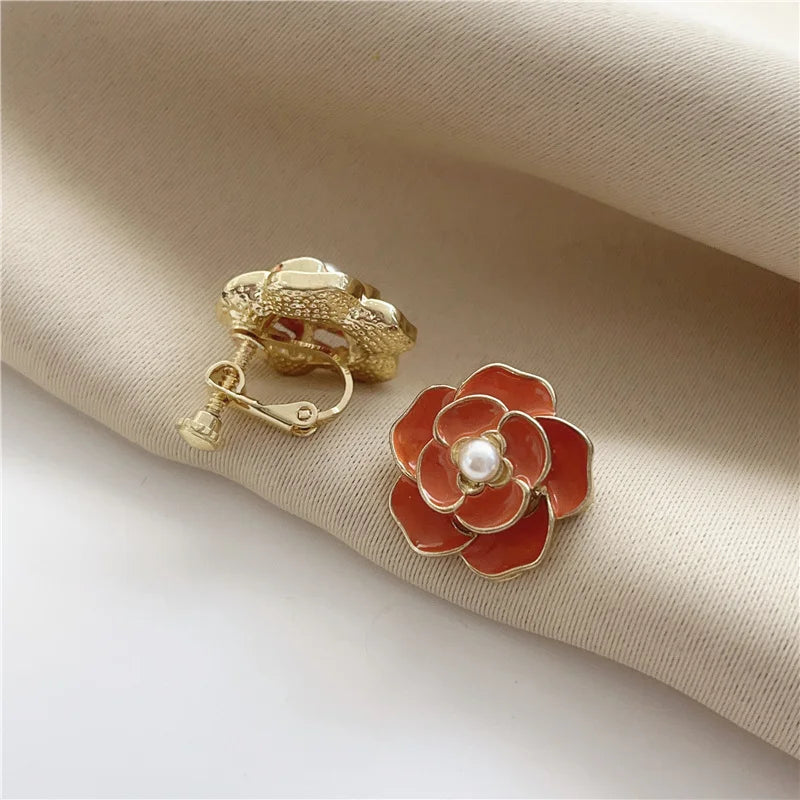 Luxurious gold-plated copper alloy women's clip earrings with screw-back clip-on design, shown in red.