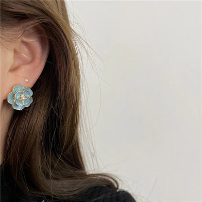 Model wearing blue enamel pearl clip on earrings, ideal for casual and formal outfits.