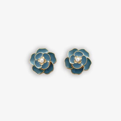 Vibrant blue enamel clip on earrings for women with a pearl center and flower design.