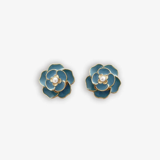 Vibrant blue enamel clip on earrings for women with a pearl center and flower design.