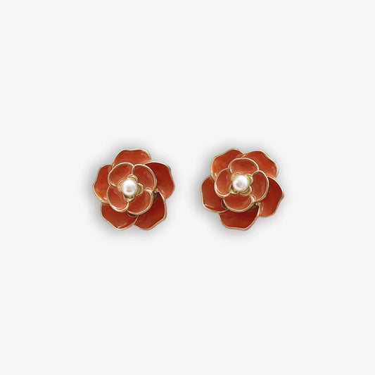 Bold red enamel clip on earrings for women with a pearl center and flower design.