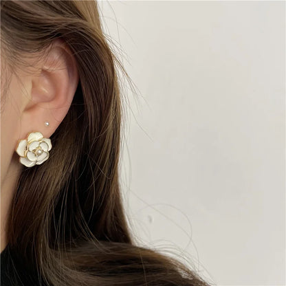 Model wearing white enamel pearl clip on earrings, perfect for adding sophistication to any outfit.