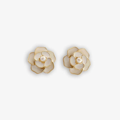 Classic white enamel clip on earrings for women with a pearl center and flower design.