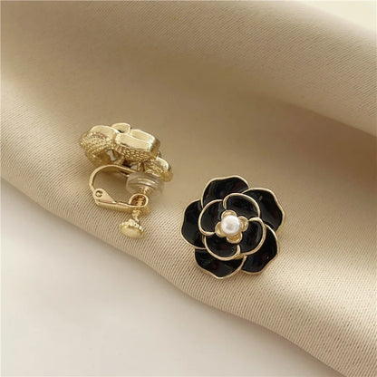 Gold-flashed copper alloy women's clip earrings with a screw-back clip-on mechanism, shown in black.